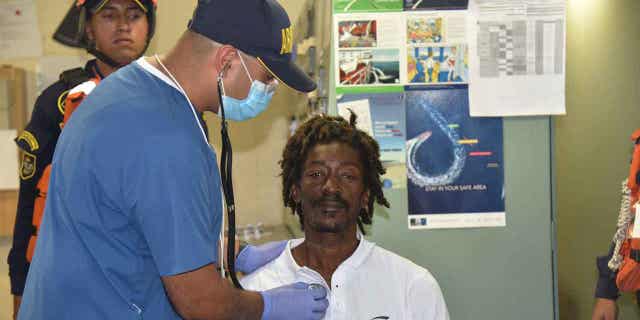 Castaway Elvis Francois is attended to by Colombian Navy members after he was rescued near the department of La Guajira at the port of Cartagena Colombia on Jan 16 2023
