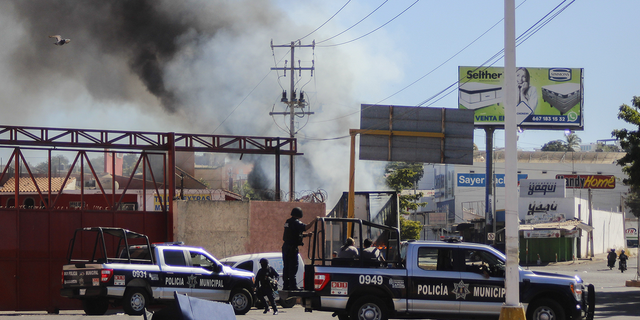 Police arrive on the scene after a store was looted in Culiacan on Thursday.