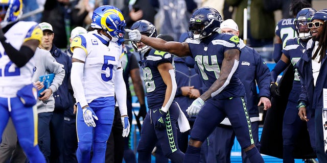 Jalen Ramsey #5 of the Los Angeles Rams argues with DK Metcalf #14 of the Seattle Seahawks after a play during the fourth quarter at Lumen Field on Jan. 8, 2023 in Seattle.
