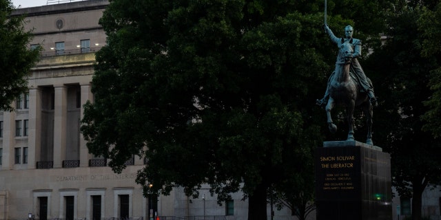 A statue of Simon Bolivar and the Stewart Lee Udall Department of the Interior Building, photographed on Friday, July 16, 2021, in Washington, D.C.