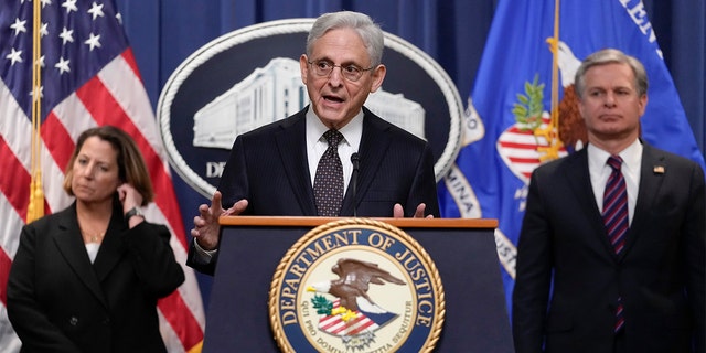 Attorney General Merrick Garland, flanked by Deputy Attorney General Lisa Monaco and FBI Director Christopher Wray, speaks during a news conference at the Department of Justice in Washington, D.C., on Friday to discuss recent law enforcement action in transnational security threats cases.