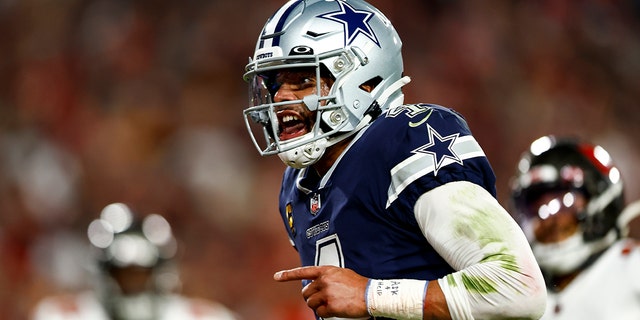 Dak Prescott #4 of the Dallas Cowboys rushes the ball for a touchdown during the second quarter of an NFL wild card playoff football game against the Tampa Bay Buccaneers at Raymond James Stadium on January 16, 2023 in Tampa, Florida.