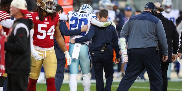 Tony Pollard (20) of the Dallas Cowboys is assisted by medical staff after suffering an injury against the San Francisco 49ers during the second quarter in an NFC divisional playoff game at Levi's Stadium Jan. 22, 2023, in Santa Clara, Calif.