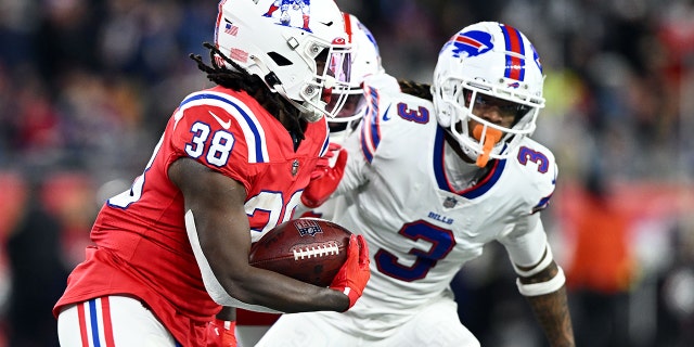 New England Patriots running back Rhamondre Stevenson, #38, rushes against Buffalo Bills safety Damar Hamlin, #3, during the second half at Gillette Stadium in Foxborough, Massachusetts, Dec. 1, 2022.