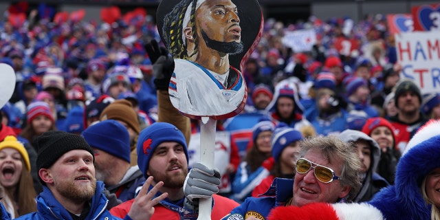 Buffalo Bills fans hold a photo of Damar Hamlin (3) during the game against the New England Patriots at Highmark Stadium.  Buffalo.