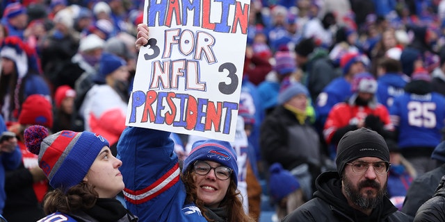 Buffalo Bills fans hold a sign for Damar Hamlin vs. New England Patriots at Highmark Stadium.