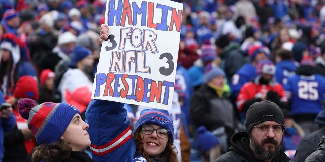 Buffalo Bills fans hold a sign of Damar Hamlin against the New England Patriots at Highmark Stadium.