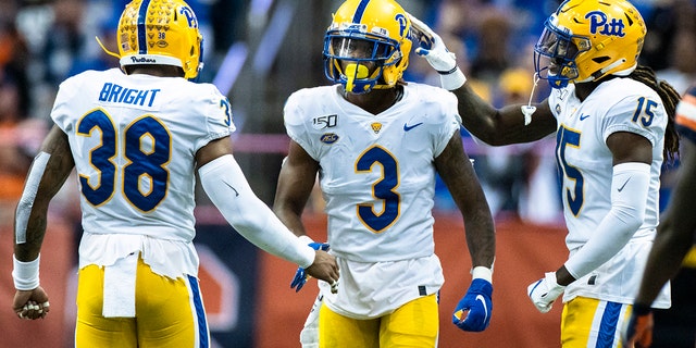 Damar Hamlin #3 of the Pittsburgh Panthers celebrates with Cam Bright #38 and Jason Pinnock #15 during the third quarter against the Syracuse Orange at the Carrier Dome on October 18, 2019 in Syracuse, New York.