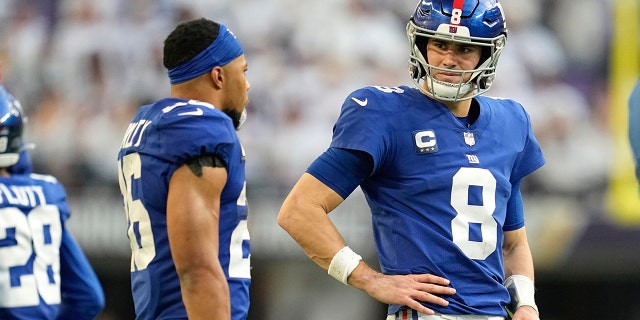 New York Giants quarterback Daniel Jones talks with running back Saquon Barkley during a Minnesota Vikings game, Saturday, Dec. 24, 2022, in Minneapolis.