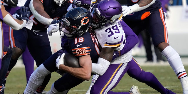 Chicago Bears wide receiver Dante Pettis (18) is tackled by Minnesota Vikings cornerback Chandon Sullivan (39) after catching a pass during the first half of an NFL football game , on Sunday, January 8, 2023, in Chicago.