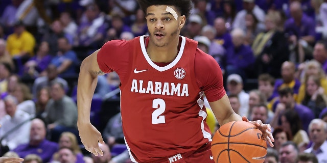 Darius Miles of the Alabama Crimson Tide drives with the ball against the LSU Tigers during a game at the Pete Maravich Assembly Center March 5, 2022, in Baton Rouge, La. 