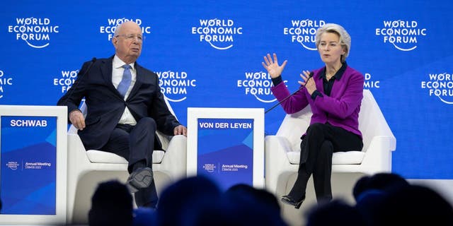 President of the European Commission Ursula von der Leyen speaks as World Economic Forum founder Klaus Schwab listens during a session of the WEF annual meeting in Davos Jan. 17, 2023.