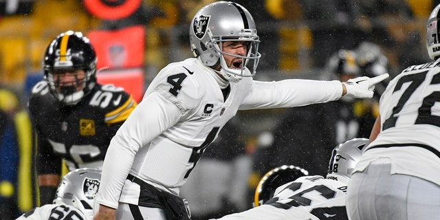 Las Vegas Raiders quarterback Derek Carr, #4, signals during the first half of an NFL football game against the Pittsburgh Steelers in Pittsburgh, Saturday, December 24, 2022. 