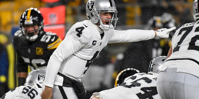 Las Vegas Raiders quarterback Derek Carr, #4, signals during the first half of an NFL football game against the Pittsburgh Steelers in Pittsburgh, Saturday, December 24, 2022. 