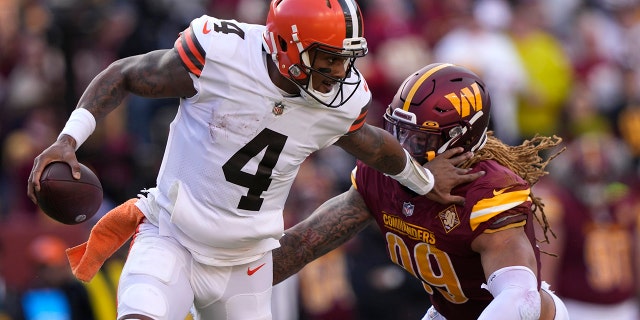 Cleveland Browns quarterback Deshaun Watson (4) gets away from Washington Commanders defensive end Chase Young (99) during the first half of an NFL football game, Sunday, Jan. 1, 2023, in Landover, Md. 