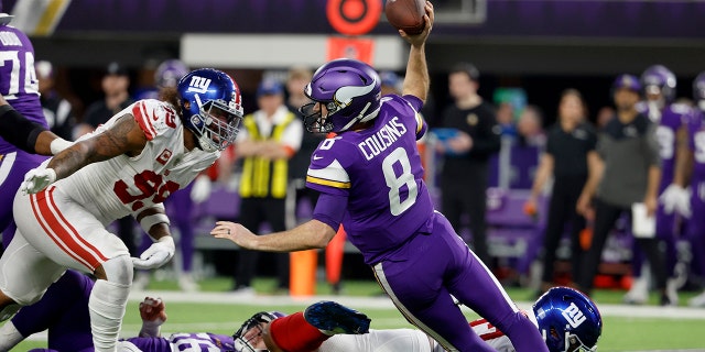 Dexter Lawrence #97 of the New York Giants tackles Kirk Cousins #8 of the Minnesota Vikings during the second quarter in the NFC Wild Card playoff game at U.S. Bank Stadium on January 15, 2023 in Minneapolis.