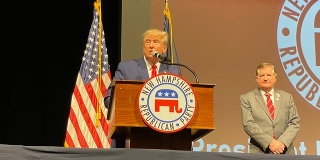 Former President Donald Trump gives the headline address at the New Hampshire GOP annual meeting, in Salem, New Hampshire on Jan. 28, 2023. Trump is joined by outgoing NHGOP chair Steve Stepanek (right), who joined Trump's campaign as a senior adviser in New Hampshire