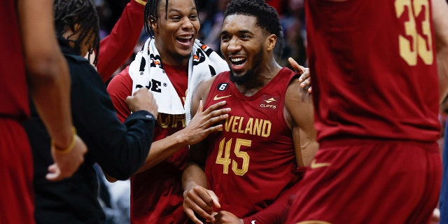 Cleveland Cavaliers guard Donovan Mitchell, #45, celebrates with teammates after making a basket to tie an NBA basketball game during the second half against the Chicago Bulls, Monday, Jan. 2, 2023, in Cleveland. 