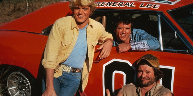 American actors (left to right) John Schneider, Tom Wopat and Ben Jones as Bo Duke, Luke Duke and Cooter, respectively, in the TV series "The Dukes of Hazzard," circa 1983. They were posing with the General Lee, a 1969 Dodge Charger prominently featured in the series.