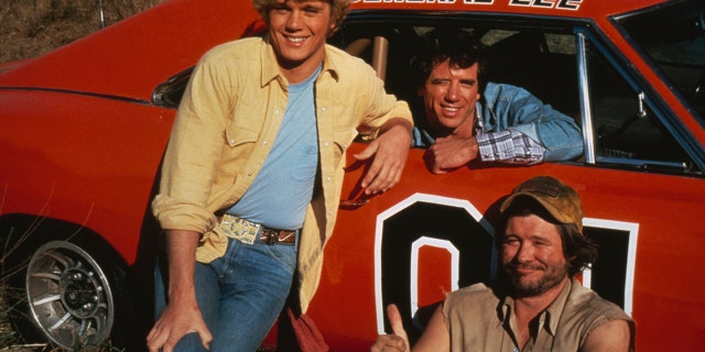 American actors (left to right) John Schneider, Tom Wopat and Ben Jones as Bo Duke, Luke Duke and Cooter, respectively, in the TV series "The Dukes of Hazzard," circa 1983. They were posing with the General Lee, a 1969 Dodge Charger prominently featured in the series.