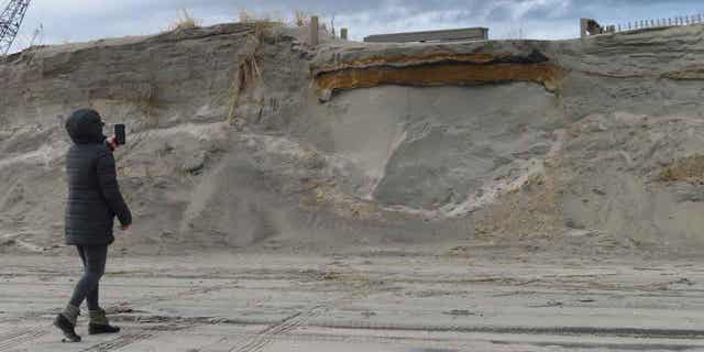 A severely eroded dune is pictured in North Wildwood, New Jersey, on Jan. 5, 2023, where a ramp down to the beach used to exist but now dead-ends in midair. North Wildwood is suing New Jersey for $21 million, asserting it has spent that amount trucking sand in to widen its beaches in the absence of a government beach replenishment project.