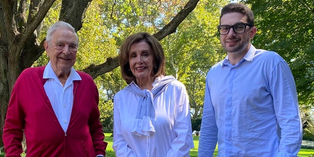 Then-House Speaker Nancy Pelosi of California poses with liberal billionaire donor George Soros, pictured on the left, and his son, Alexander, pictured on the right.
