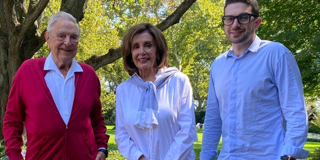 Then-House Speaker Nancy Pelosi of California poses with liberal billionaire donor George Soros, pictured on the left, and his son, Alexander, pictured on the right.