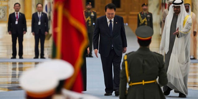 South Korean President Yoon Suk Yeol, center, and Emirati leader Sheikh Mohammed bin Zayed Al Nahyan, right, attend a ceremony at Qasar Al Watan in Abu Dhabi, United Arab Emirates, Sunday, Jan. 15, 2023. Yoon received an honor guard welcome Sunday on a trip to the United Arab Emirates, where Seoul hopes to expand its military sales while finishing its construction of the Arabian Peninsula's first nuclear power plant. (AP Photo/Jon Gambrell)