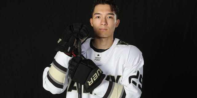 Army hockey player Eric Huss poses for a photo