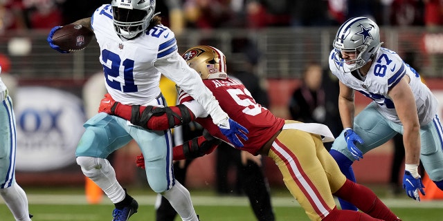 Dallas Cowboys running back Ezekiel Elliott, #21, runs past San Francisco 49ers linebacker Azeez Al-Shaair, #51, during the fourth quarter of a NFC divisional round game at Levi's Stadium in Santa Clara, California, Jan. 22, 2023.