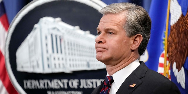 FBI Director Christopher Wray listens during a news conference at the Department of Justice on Jan. 27. 