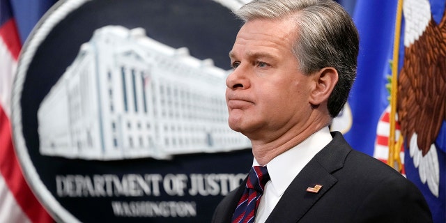 FBI Director Christopher Wray listens during a news conference at the Department of Justice in Washington Jan. 27, 2023. 