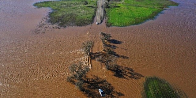 Three vehicles are submerged on Dillard Road west of Highway 99 in south Sacramento County in Wilton, Calif., Sunday, Jan. 1, 2023, after heavy rains on New Year's Eve produced levee breaks.