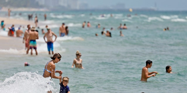 Beachgoers are shown on Fort Lauderdale Beach on July 14, 2022, in Florida. 