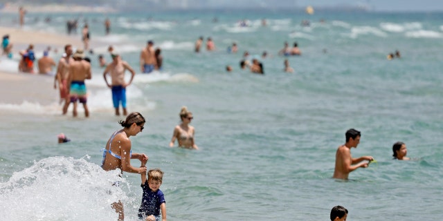 Beachgoers are shown on Fort Lauderdale Beach on July 14, 2022, in Florida. 