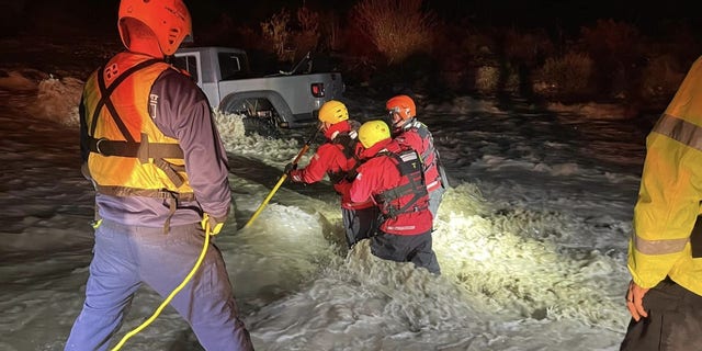 A family of three was rescued from an SUV in Lytle Creek, California on Sunday, after raging floodwaters engulfed the vehicle.