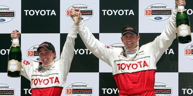 Frankie Muniz, left, celebrates with Champ Car driver Rhys Millen after winning the 29th annual Pro/Celebrity race in Long Beach, California on April 9, 2005.