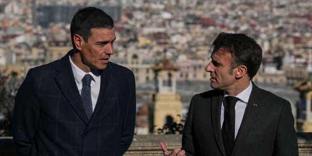 French President Emmanuel Macron, right, talks with Spanish counterpart Pedro Sánchez in Barcelona, Spain, on Jan. 19, 2023. The two leaders signed a friendship treaty on Thursday in Barcelona.
