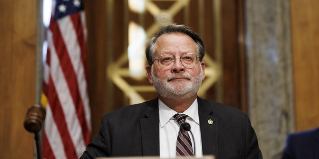 Sen. Gary Peters, a Democrat from Michigan and chairman of the Senate Homeland Security and Governmental Affairs Committee, gavels in during a hearing in Washington, D.C., on Nov. 17, 2022.