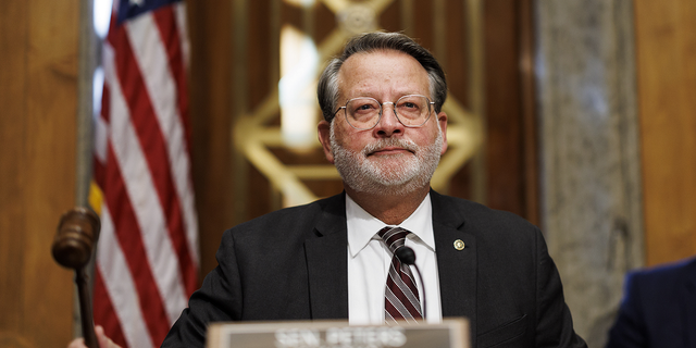 Sen. Gary Peters, a Democrat from Michigan and chairman of the Senate Homeland Security and Governmental Affairs Committee, gavels in during a hearing in Washington, D.C., on Nov. 17, 2022.