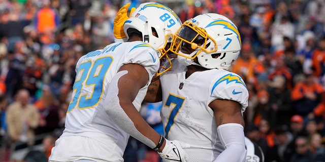 Los Angeles Chargers tight end Gerald Everett, #7, celebrates his touchdown with teammate Donald Parham Jr., #89, during the first half of an NFL football game in Denver, Sunday, Jan. 8, 2023. 