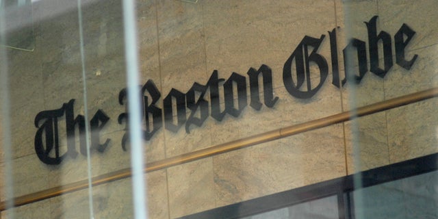 The Boston Globe logo as seen through the windows across from the new location of the Boston Globe at 53 State Street, Boston, at one Exchange Place in the Exchange Building.