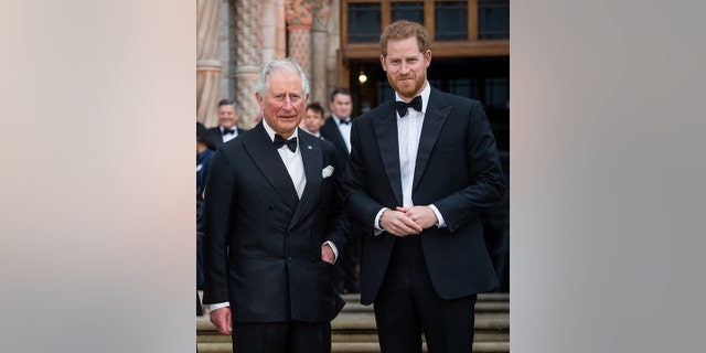 King Charles in a tuxedo poses with his son Prince Harry on the steps of the National History Museum in 2019