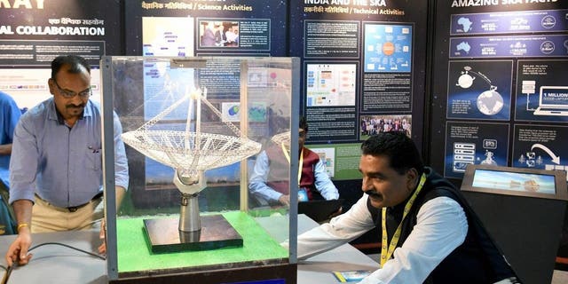 A model arranges a scale model of a Giant Metrewave Radio Telescope (GMRT) antenna on display during Vigyan Samagam, a massive multi-venue science exhibition, at the Visveswaraya Industrial and Technology Museum in Bangalore on July 29, 2019.