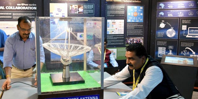 An exhibitor arranges a scaled-down model of Giant Metrewave Radio Telescope (GMRT) Antenna on display during ‘Vigyan Samagam,’ a multi-venue mega-science exhibition, at the Visveswaraya Industrial and Technological Museum in Bangalore on July 29, 2019.