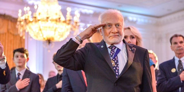 Buzz Aldrin salutes the U.S. Flag is brought in to a dinner commemorating the 50th anniversary of Apollo 11's return to Earth at the Richard Nixon Presidential Library and Museum in Yorba Linda, California, July 23, 2019. 