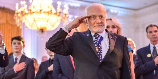 Buzz Aldrin salutes the U.S. Flag is brought in to a dinner commemorating the 50th anniversary of Apollo 11's return to Earth at the Richard Nixon Presidential Library and Museum in Yorba Linda, California, July 23, 2019. 