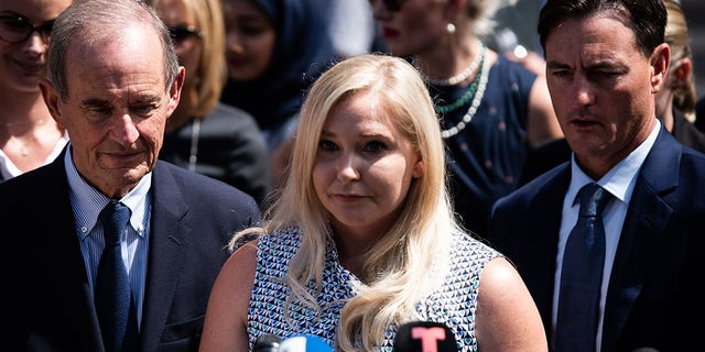 Virginia Giuffre, an alleged victim of Jeffrey Epstein, center, pauses as she speaks to members of the media outside federal court in New York, U.S., Tuesday, Aug. 20.  27, 2019. 