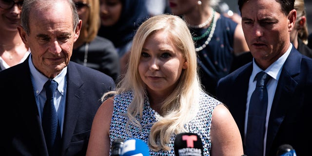 Virginia Giuffre, an alleged victim of Jeffrey Epstein, center, pauses while speaking with members of the media outside of federal court in New York, U.S., on Tuesday, Aug. 27, 2019. 