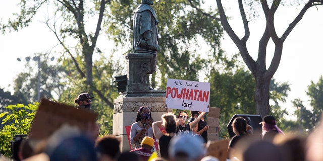 Protesters surround a statue of Christopher Columbus before marching, eventually returning and pulling it down in Richmond, Virginia, June 9, 2020. 